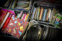 vinyl records, cd\'s and books in plastic baskets are for sale on a feal market in monastiraki in athens