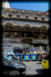 a ruin between other buildings in monastiraki in athens