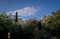 a woman goes past the herodes atticus theatre in athens