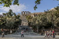 tourists going past the stairs, where lead up to the herodes atticus theatre in athens