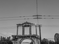 behind tram lines you see the hadrian\'s arch, black-and-white