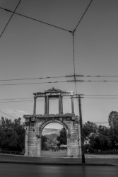 behind tram lines you see the hadrian\'s arch, black-and-white