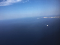 an aerial view to the mediterranen sea with the island rhodes and a ferry boat