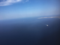 an aerial view to the mediterranen sea with the island rhodes and a ferry boat