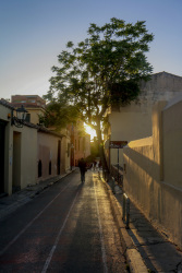 an empty alley in plaka in athens in the backlight of the evening sun