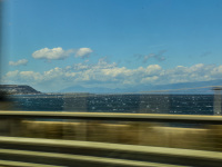 the gulf of corinth with many waves out of the carwindow while driving