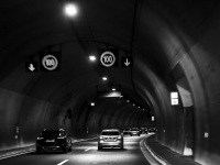 in a tunnel on the highway 5 near gavrolimni in greece with some cars in front, black-and-white