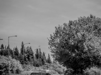 an old pickup is driving on an old road near trikala in greece, black-and-white