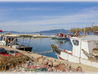fishing nets and fisher boats at the harbor of arkitsa