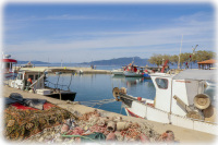 fishing nets and fisher boats at the harbor of arkitsa
