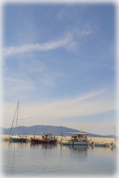 coloful fisherboats are laying like a line between the sky and the sea in arkitsa