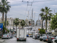 view from the street to pasalimani in piraeus with many boats and yachts at the harbor