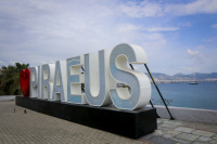 the piraeus sign with the big lettering \"Piraeus\" and a red heart at the harbor