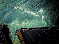 on a ferry boat to rhodes a turquoise seawater behind a loading flap, that ist closing