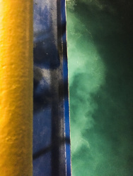 at the top is a yello and blue shiprailing and below the turquiose sea, on the way to rhodes