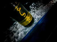 on the ferry to rhodes is in front of a nightly foam of the sea is a bottle of greek beer esa