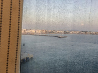 view through a turbid shipwindow on the harbor of piraeus with sea and the city