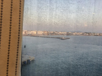 view through a turbid shipwindow on the harbor of piraeus with sea and the city